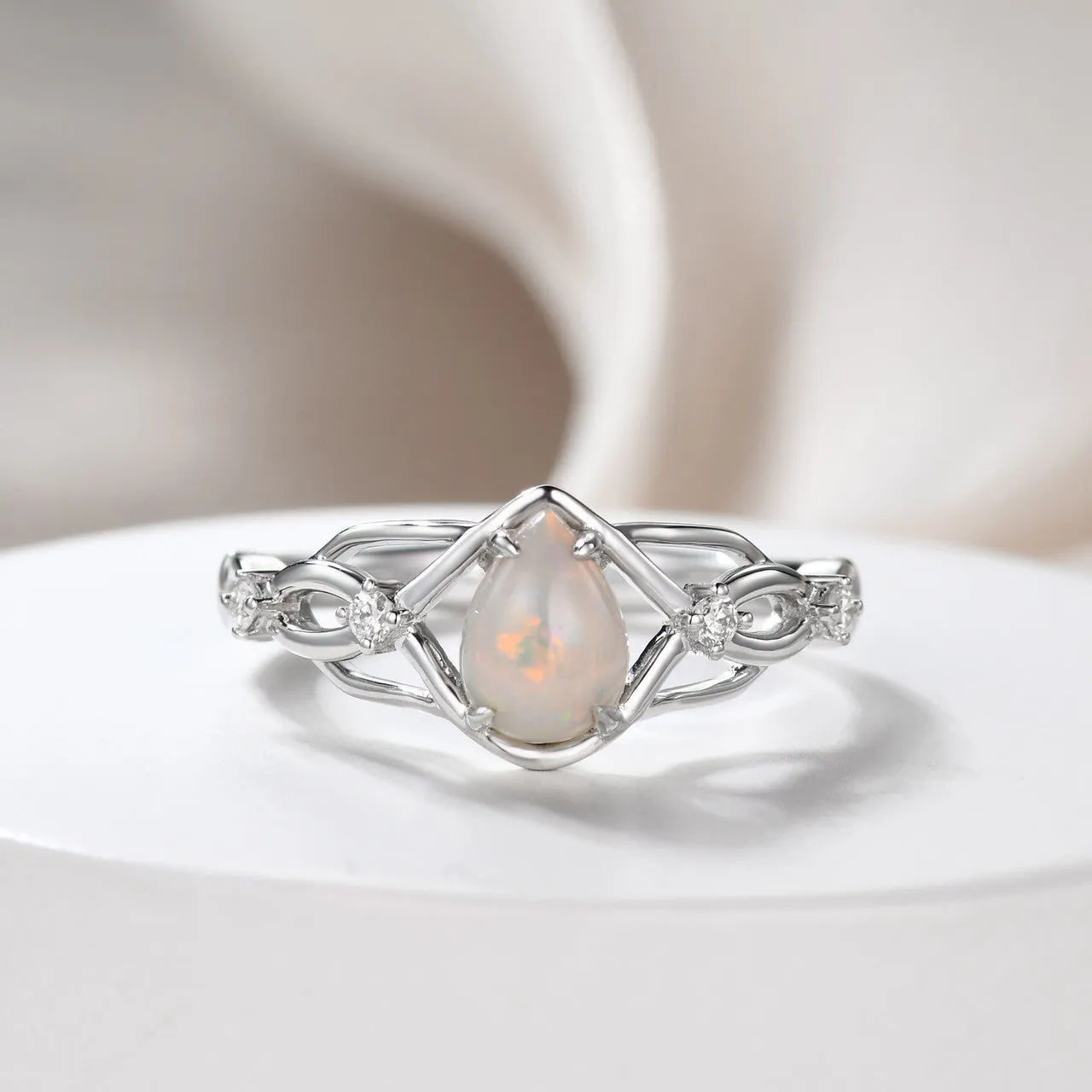 Australian opals Celtic style engagement ring set with 4 little diamonds.