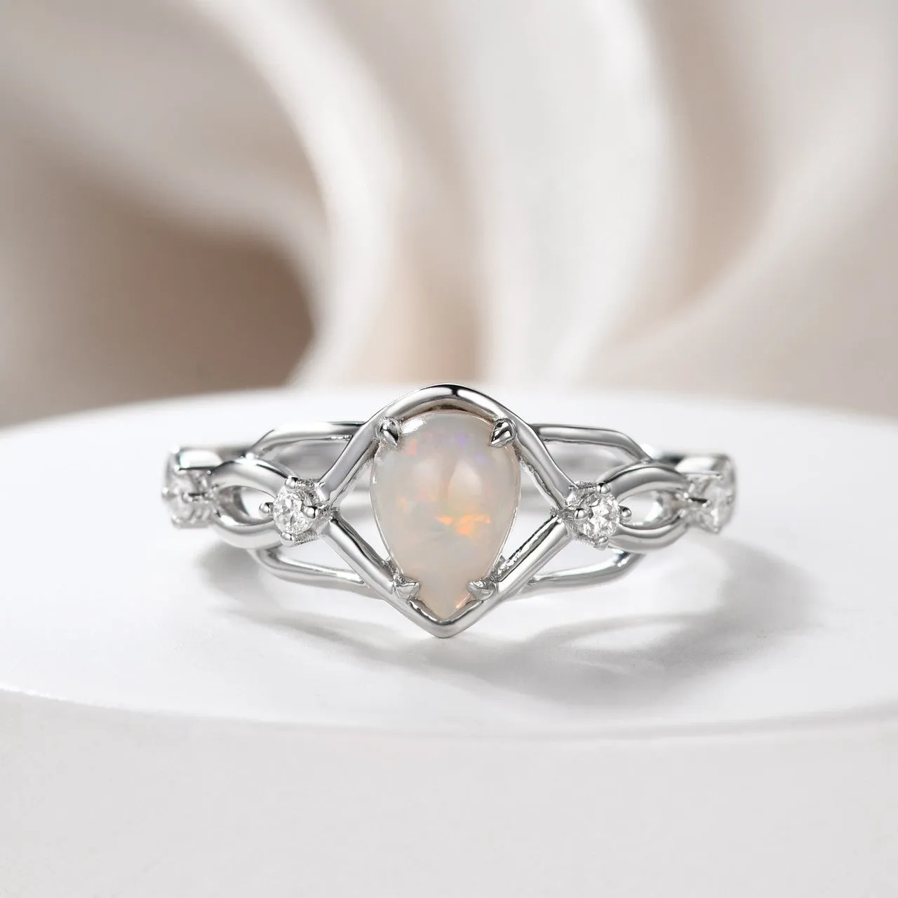 Australian opals Celtic style engagement ring set with 4 little diamonds.