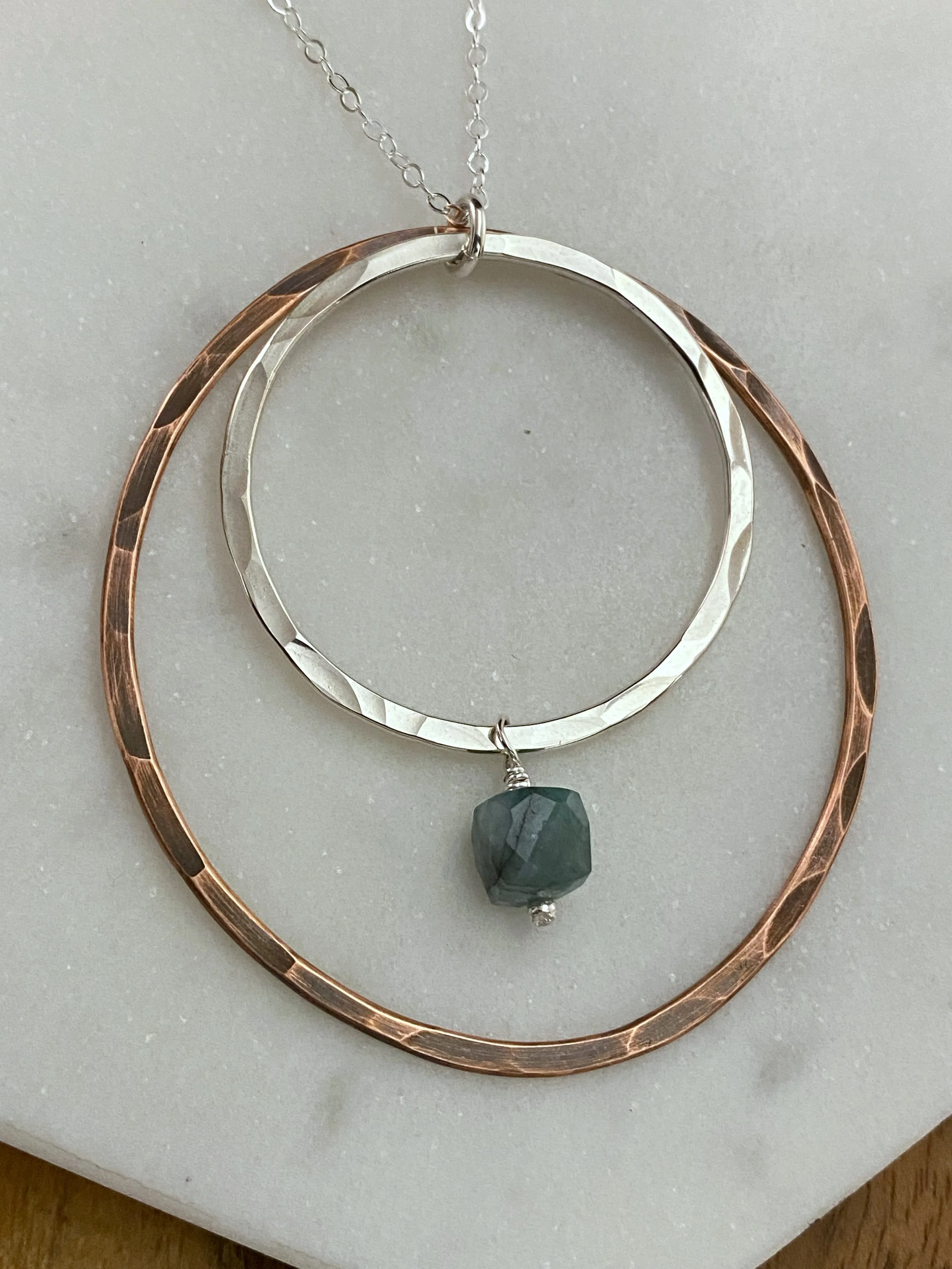 Sterling silver and copper forged hoop necklace with emerald